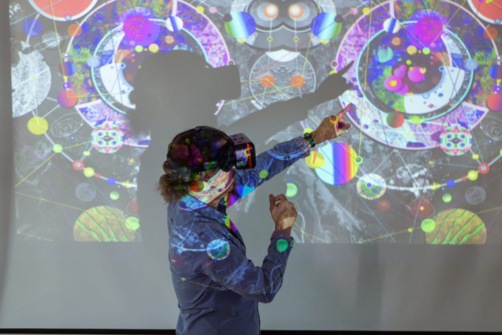 Digital art Person interacting with colorful digital projection display.